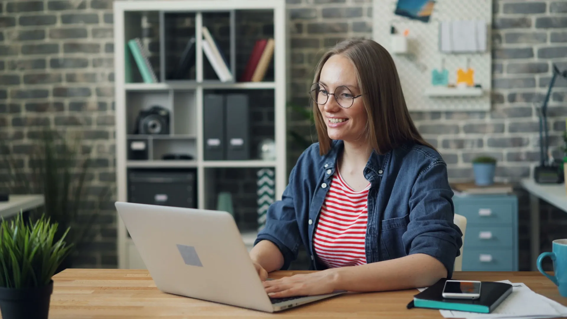 Confident IB Diploma exam prep coach using a laptop for student success